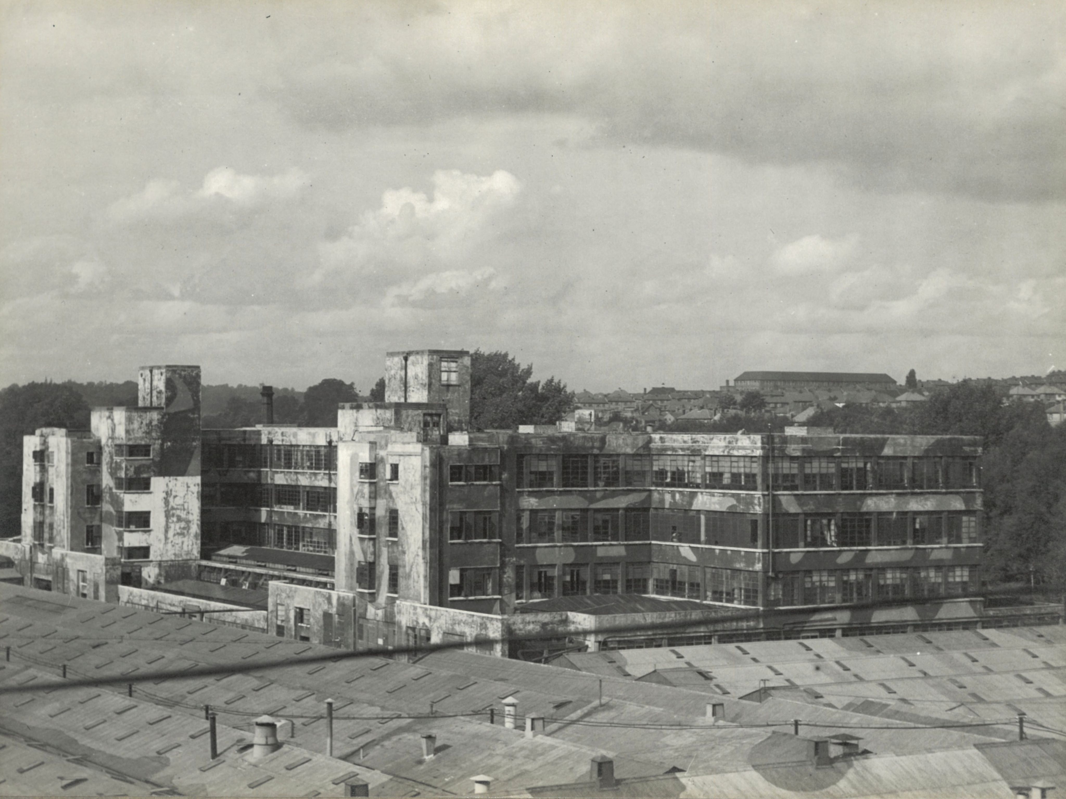A black and white photograph of a building at Apsley Mill which has been painted in a camouflage pattern. 
